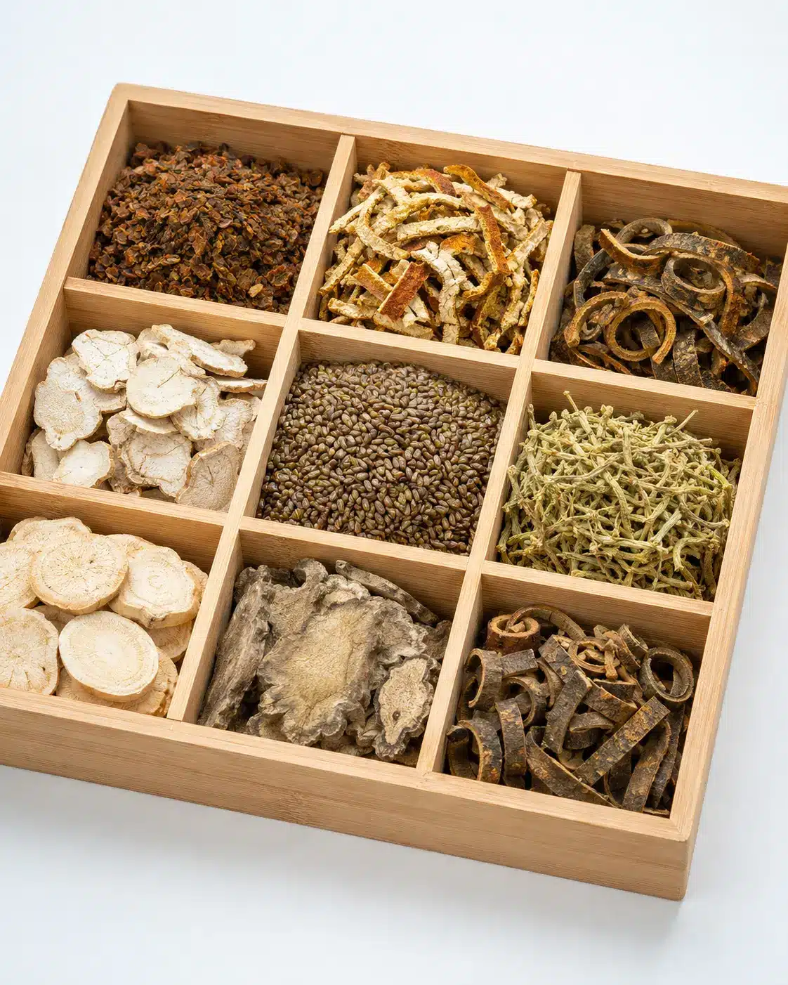 Assorted Chinese herbal slices sorted by type in wooden tray