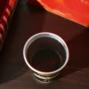 Close-up detail of red date black soybean mulberry herbal tea in cup