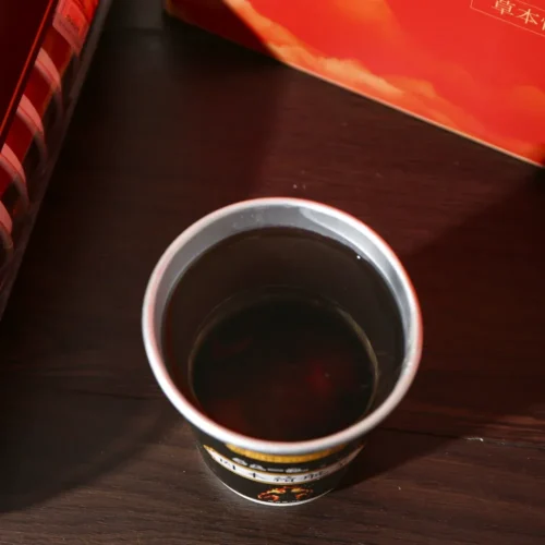 Close-up detail of red date black soybean mulberry herbal tea in cup